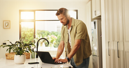 Typing, laptop and man in kitchen, home and planning for blog on social media, website and...