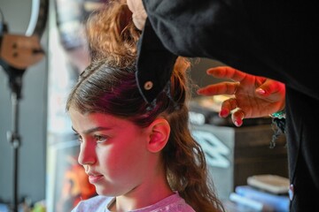 Fototapeta premium High resolution image of a single beautiful twelve year old Caucasian girl photo shot getting makeup and hair done