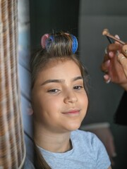 Fototapeta premium High resolution image of a single beautiful twelve year old Caucasian girl photo shot getting makeup and hair done