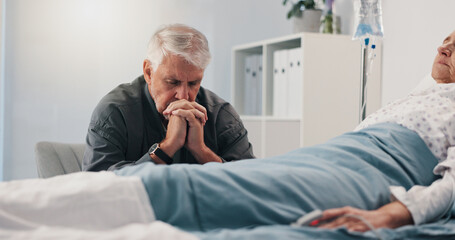Fototapeta premium Healthcare, hospital bed and senior man with hope, couple and prayer for recovery of partner or sad. Clinic, worried and elderly person with concern for cancer, sick and medical treatment for patient