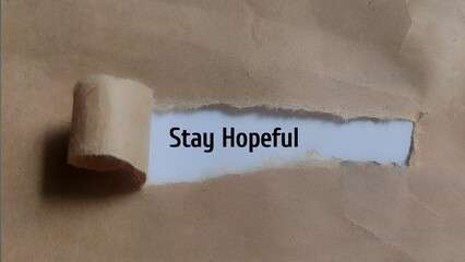 Stay Hopeful - Positive Message Revealed Through Torn Brown Paper