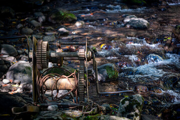An old rusty winch in a summer stream