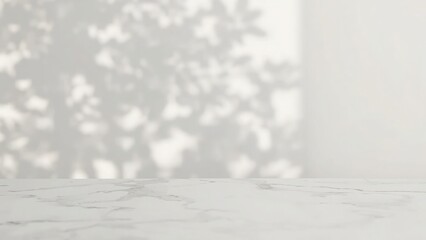 Fototapeta premium White marble tabletop with blurred sunlight and leaf shadows background