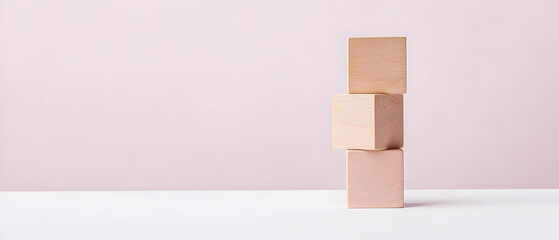 Stacked Light Beige Wooden Blocks On Pastel Pink Background