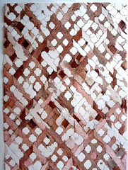 the image shows a flat surface covered in a textured, geometric pattern. the pattern features intersecting diagonal bands in shades of brown