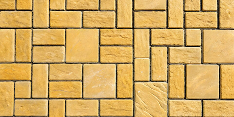 Golden yellow sandstone tiles in rectangular grid pattern with visible natural grain textures and consistent mortar joints.