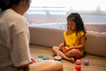 Preschool kids playing with toy at home. Wooden rainbow, eco-friendly playthings. Children organized storage promote learning, fun, and sustainability in a safe space.