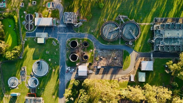 Carole Park STP, Brisbane, Queensland, Australia: Aerial Image of Circular Clarifiers, Settling Tanks, Algal Pond, and Water Treatment Infrastructure at a Modern Sewage Treatment Plant in a Green