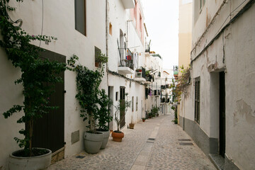 Fototapeta premium Streets and views of the ancient walled citadel of Dalt Vila, a UNESCO World Heritage Site, on the island of Ibiza in Spain.