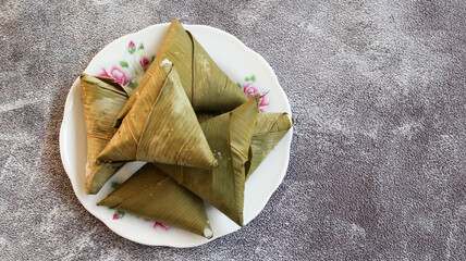 sumpil or Lontong segitiga, lontong with triangel shaped is an Indonesian dish. Rice is rolled inside a leaf and boiled, then cut into small cakes as a staple food replacement of steamed rice.top view