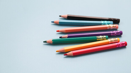 Various colored pencils isolated on blue background. copy space	