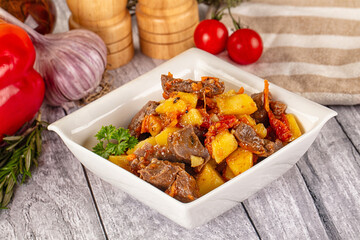 Rogiut with meat, potato and tomatoes