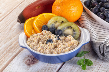 Oats porridge with blueberry, kiwi and orange