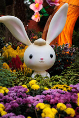 Cute and adorable cartoon-like rabbit emerging from flowers at gardens by the bay - Singapore