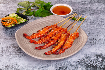 Grilled prawn skewer served sauce