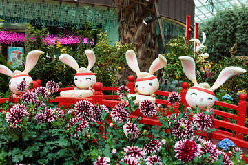 Group of cute and adorable cartoon-like rabbits emerging from flowers at gardens by the bay