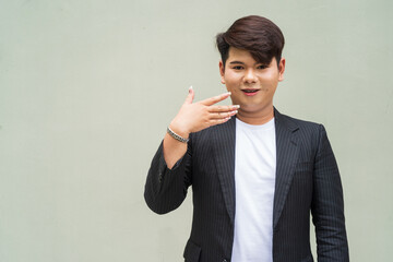 portrait of a young cute gay businessman looking shocked and surprised