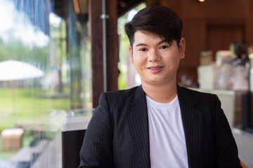 Obraz premium Young cute gay man makeup artist businessman in coffee shop restaurant wearing business clothes