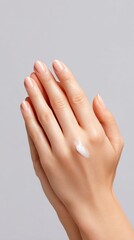 Vegan face care for everyday A close-up of hands applying moisturizer, showcasing skincare routine and self-care practices.