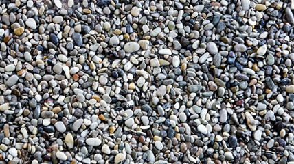 Smooth Azov pebble texture for landscaping or construction with mixed colors, copy space
