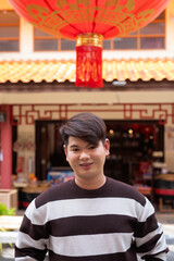 Fototapeta premium Young gay man in Chinese garden outdoors market