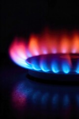 Close-up of a vibrant blue and orange gas burner flame, burning intensely against a dark background Perfect for illustrating heat, energy, or cooking concepts , orange, appliance
