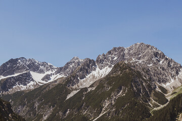 Fototapeta premium Alpine mountain landscape panorama blue sky and snow Austria.