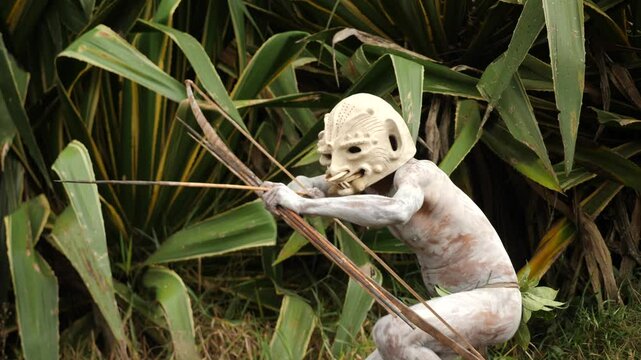 Asaro Mudmen tribe bow hunting. Papuan tribe dance. Mount Hagen tribe festival. Cultural event. Indigenous men in native costumes. High quality 4k footage
