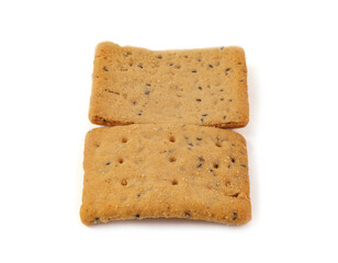 Pile of square whole grain crackers with seeds on white background – healthy baked snack food...