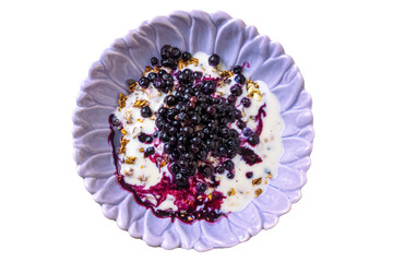 Purple bowl with yogurt, granola, and fresh blueberries. Isolated object