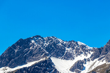 Alpine mountain landscape panorama blue sky and snow Austria.