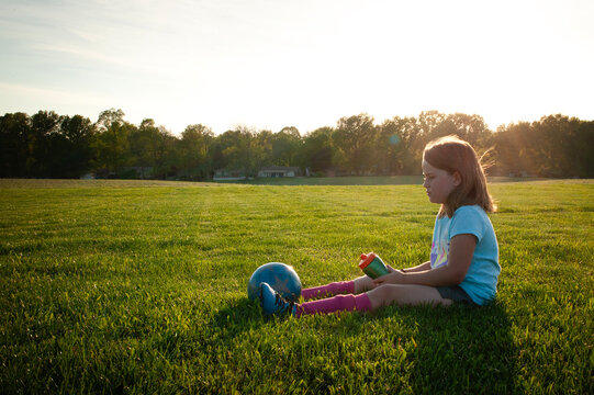 Young girl taking water break during soccer game