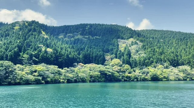 Blue sky, white clouds, green lake water - Lake Ashi