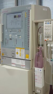 Hemodialysis machine with blood bag and tubes in a clinical environment for renal replacement therapy during a medical procedure.