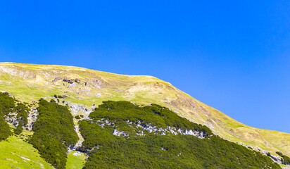 Fototapeta premium Alpine mountain and hill landscape panorama blue sky Tyrol Austria.