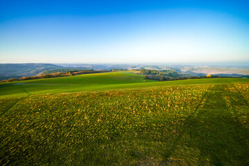 View of the landscape at the Meerfelder Maar. Nature at the crater lake in the Volcanic Eifel National Park. The surrounding area near Meerfeld at sunset in the evening.
