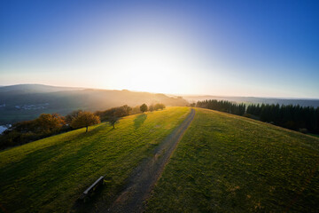 View of the landscape at the Meerfelder Maar. Nature at the crater lake in the Volcanic Eifel National Park. The surrounding area near Meerfeld at sunset in the evening.
