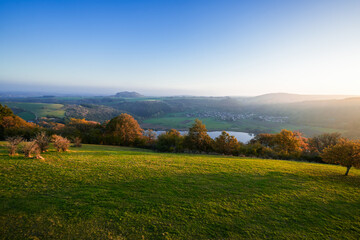 View of the landscape at the Meerfelder Maar. Nature at the crater lake in the Volcanic Eifel National Park. The surrounding area near Meerfeld at sunset in the evening.
