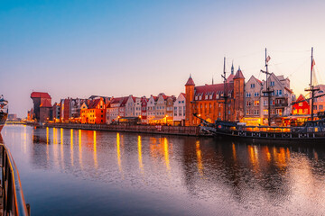 Fototapeta premium Gdansk with Motlawa river in Poland. Old town colourful house with Stragania Gate