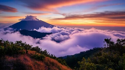 Volcanic mountain peak above clouds at sunrise - Powered by Adobe