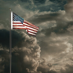 American flag waving under a cloudy sky
