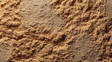 Sandy wall texture in warm earth tones, a glimpse of nature's raw beauty