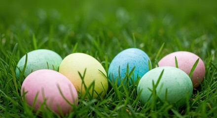 Fototapeta premium Pastel easter eggs hidden in green grass