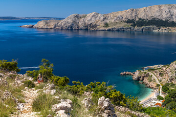 Obraz premium Hiking trail on the island of KRK, high mountains, gorge and the blue Adriatic Sea,