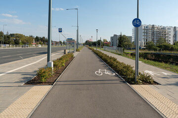A modern, separated two-way bicycle lane with clear markings and signage. This new asphalt...