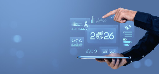 Business hand interacting with futuristic 2026 digital interface on tablet screen.