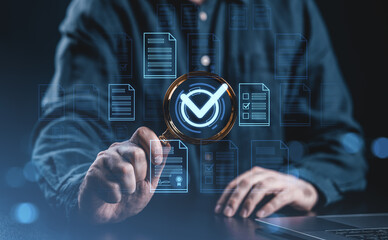 Businessman analyzing digital documents with magnifier and checkmark symbol.