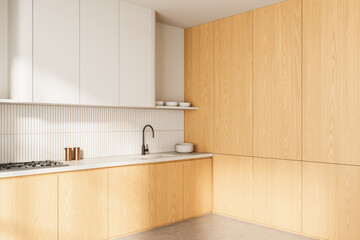 Modern minimalist kitchen interior with light wood cabinetry and white upper cupboards in natural lighting. 3D Rendering