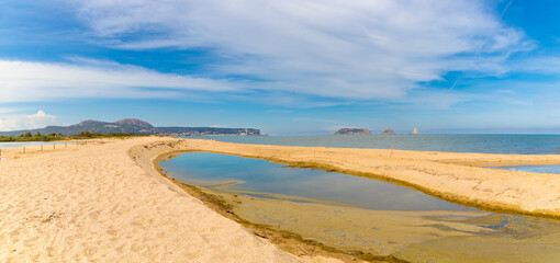 Panoramic view from Gola del Ter, Spain: Montgrí mountains, L'Estartit village, and Medes Islands archipelago meet the Costa Brava sea.
