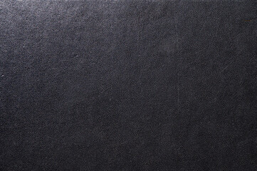 Black leather book cover close up. Abstract black leather sofa background.